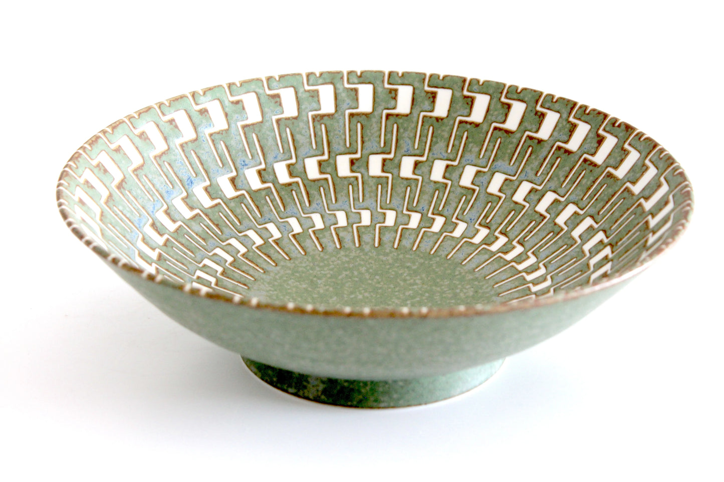 Elegant Japanese ceramic salad bowl with a soft green glaze and intricate geometric pattern in ivory and brown.