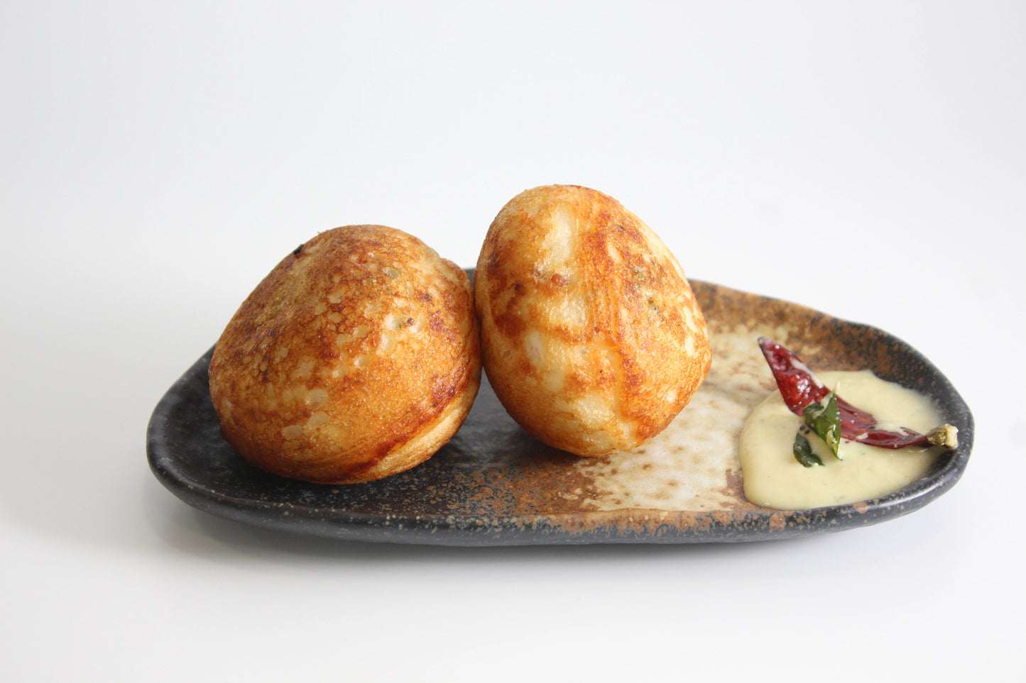 yellow & gray stoneware semi circular snack plate with Paniyaram & chutney