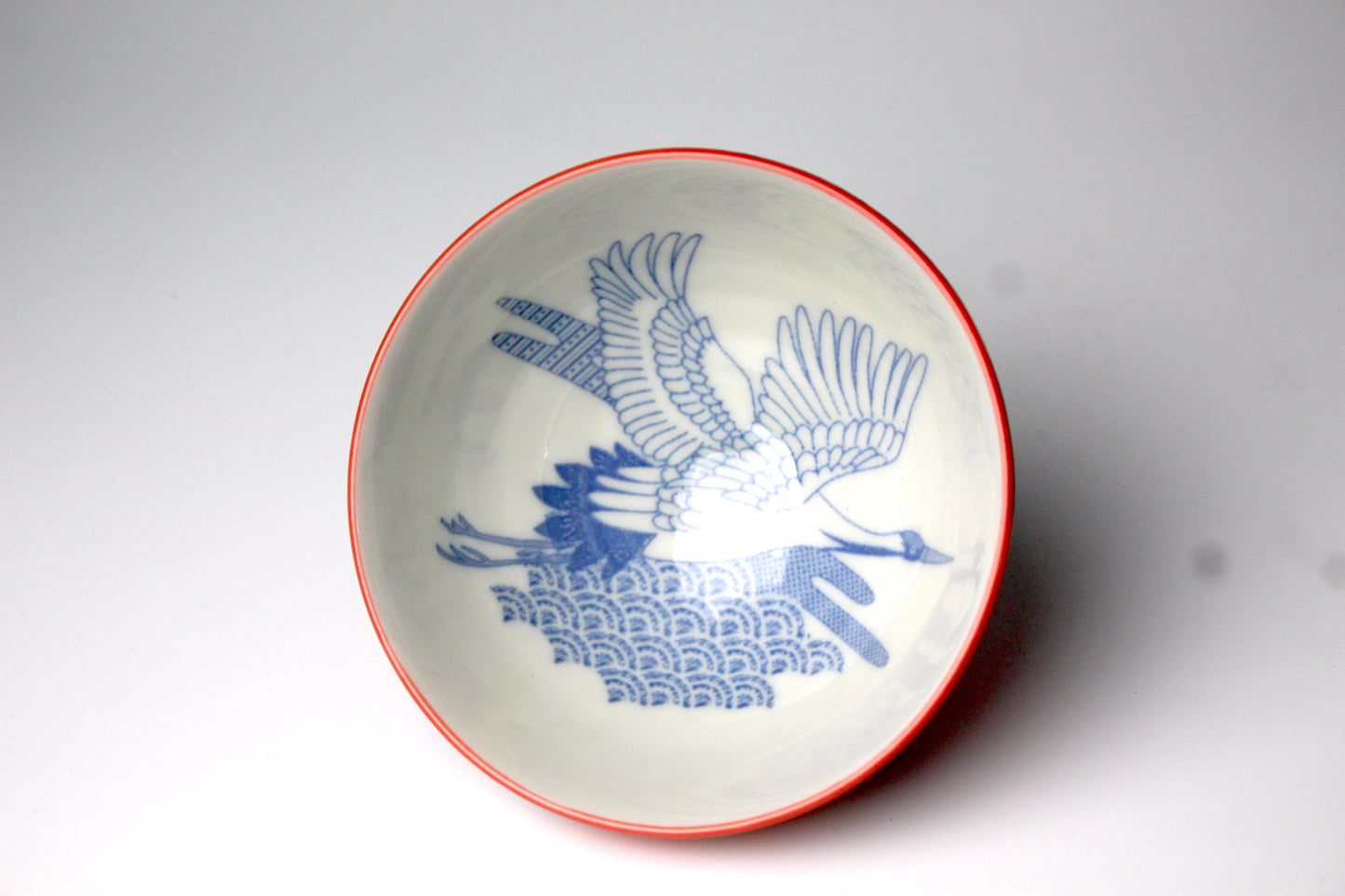 Japanese rice bowl featuring an elegant design of crane in flight on the inside.