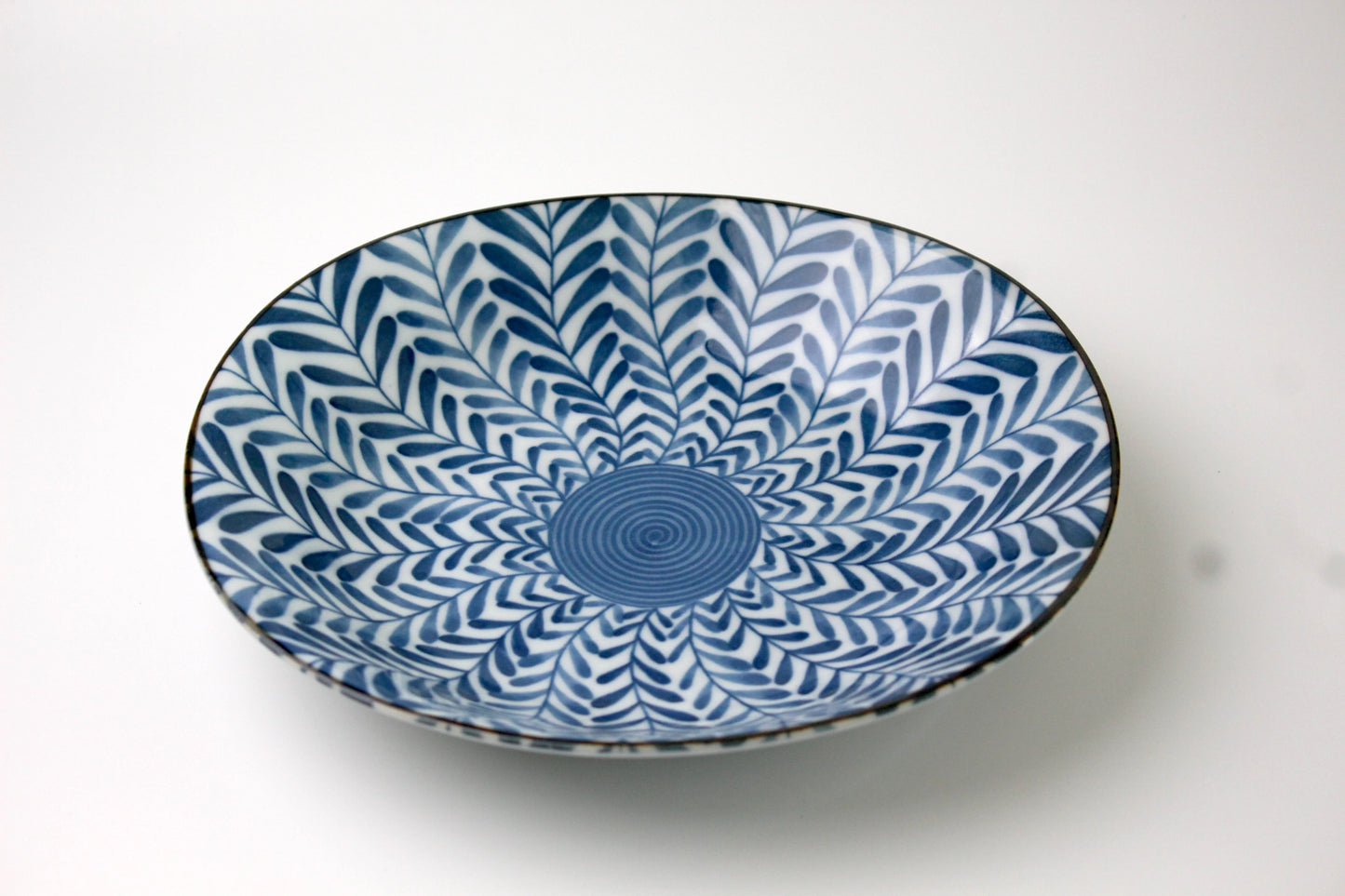 A beautifully crafted Japanese porcelain plate in Saikai style, featuring leaves.
