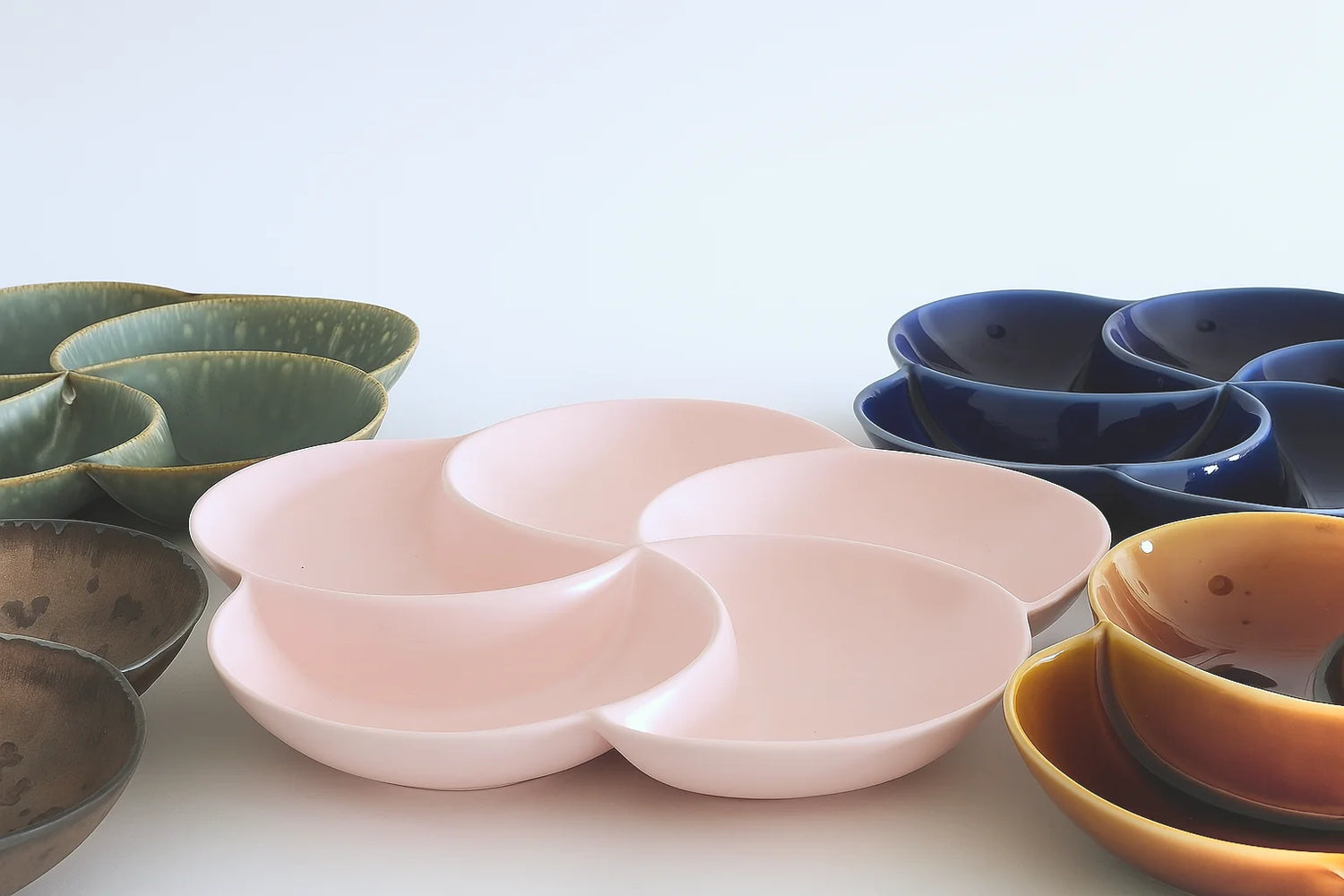 Set of green, bronze, blue, amber & pink ceramic sectional dining plates