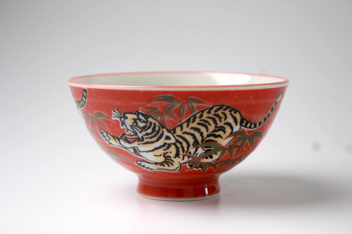 Traditional Japanese rice bowl with a vibrant red background featuring an intricate hand-painted tiger design, symbolizing strength and courage.