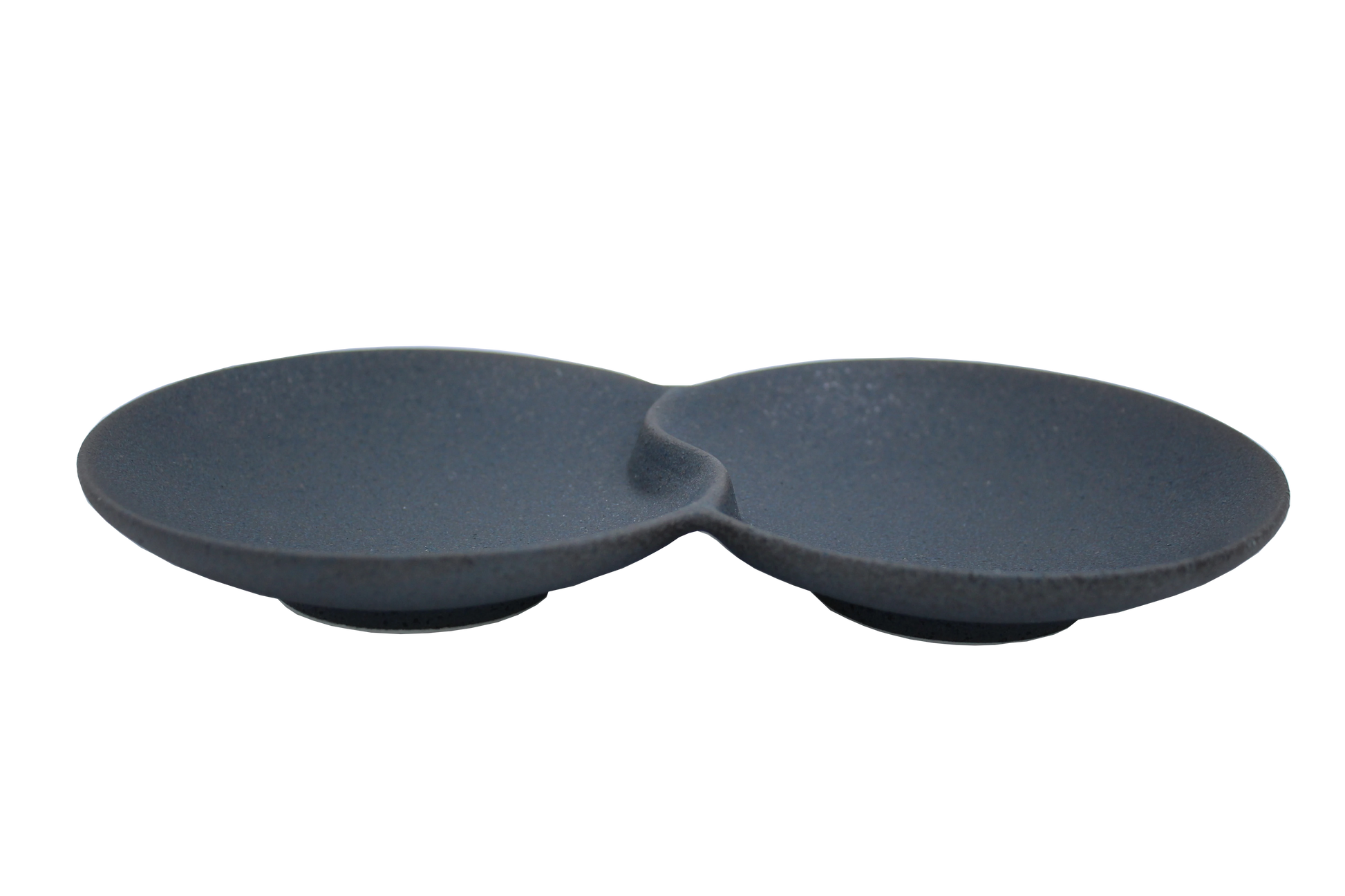 An isometric view of the Missera Hotate, a matte black ceramic divided serving dish with two circular sections joined in the center like a clam shell. Perfect as a multi compartment serving dish for snacks and dips.