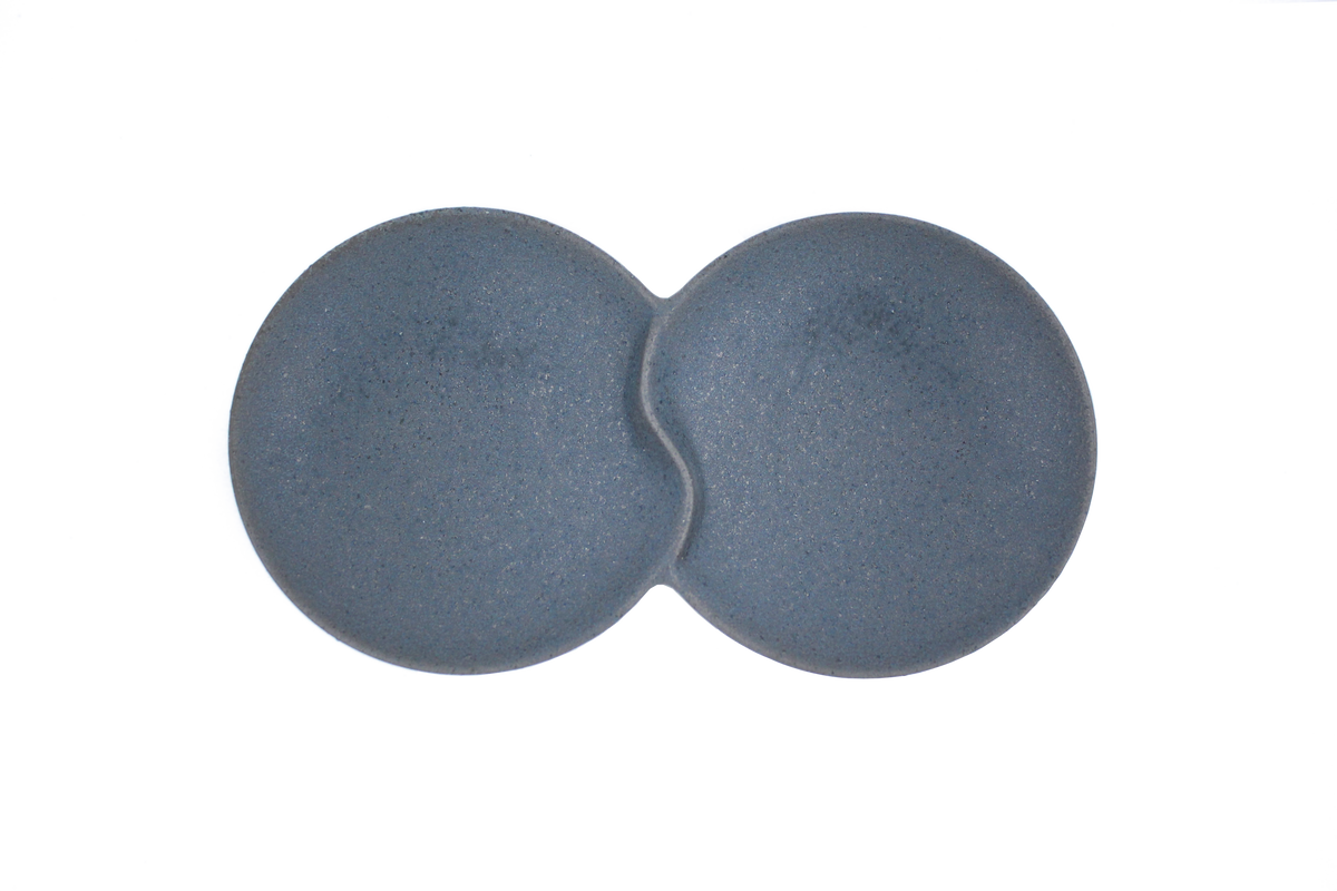 A top-down view of the Missera Hotate, a matte black ceramic divided serving dish with two circular sections joined in the center like a clam shell. Perfect as a multi compartment serving dish for snacks and dips.