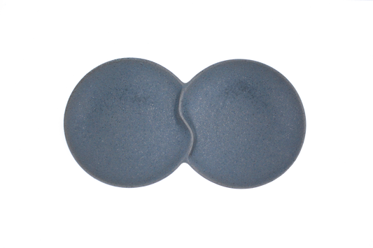 A top-down view of the Missera Hotate, a matte black ceramic divided serving dish with two circular sections joined in the center like a clam shell. Perfect as a multi compartment serving dish for snacks and dips.