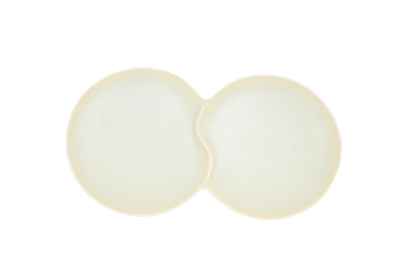 A top-down view of the Missera Hotate, a cream ceramic divided serving dish with two circular sections joined in the center like a clam shell. Perfect as a multi compartment serving dish for snacks and dips.