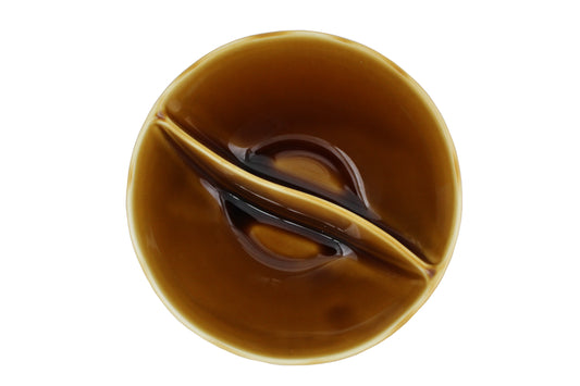 A top view of the Missera Kari, an amber colored divided bowl