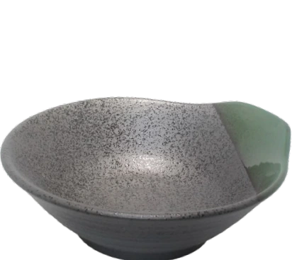 textured serving bowl or katori with a green handle iso view